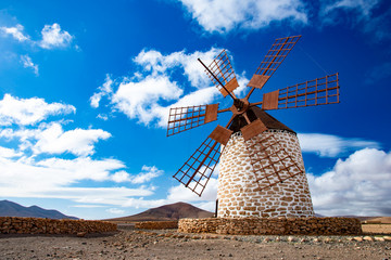 tefia windmill with blue sky and clouds in fuerteventura