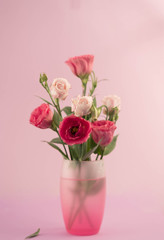 bunch of white and pink eustoma flowers in glass vase