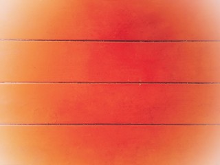 The background image of the horizontal wooden wall painted in bright orange.