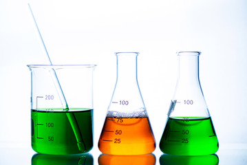 chemical liquid containing in flask with lab glassware on white background, lab research and development concept.	