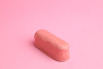 delicious pink chocolate cake in color background