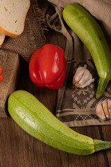 Red chilies with zucchinies on a rustic towel