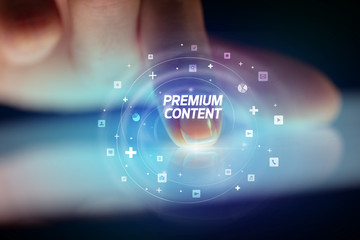 Finger touching tablet with social media icons and PREMIUM CONTENT