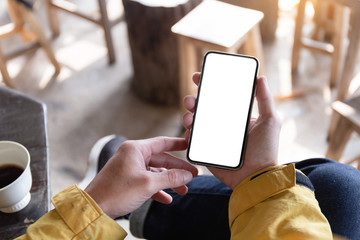 Mockup image blank white screen cell phone.man hand holding texting using mobile on desk at coffee shop.background empty space for advertise text.people contact marketing business,technology