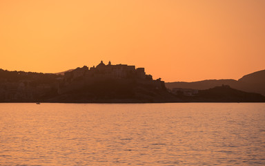 Sun setting over Calvi citadel in Corsica