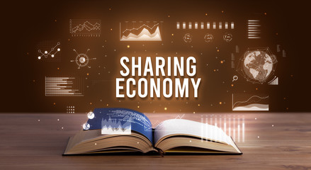 SHARING ECONOMY inscription coming out from an open book, creative business concept