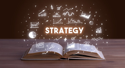 STRATEGY inscription coming out from an open book, business concept