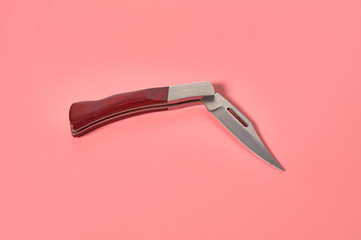 One metal tourist knife with wooden handle. Survival concept