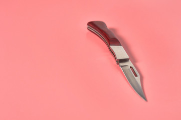 One metal tourist knife with wooden handle. Survival concept. Copy space
