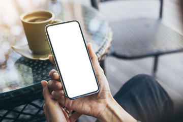 Mockup image blank white screen cell phone.man hand holding texting using mobile on desk at coffee shop.background empty space for advertise text.people contact marketing business,technology