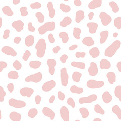 Pink spots on a white background. Animal print. Spots of a cow and dolmatins. Seamless pattern for fabric, for wallpaper, for paper, for plastic and other surfaces.