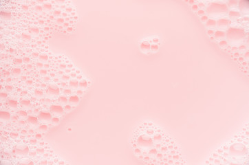 Pink soap bubbles and pink water as cute youth abstract background, copy space.
