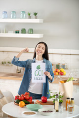 Beautiful girl standing in front of the kitchen table.