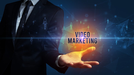 Elegant hand holding VIDEO MARKETING inscription, social networking concept
