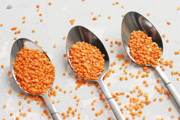 three spoons of orange cereals are lined up in a row