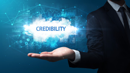 Hand of Businessman holding CREDIBILITY inscription, successful business concept