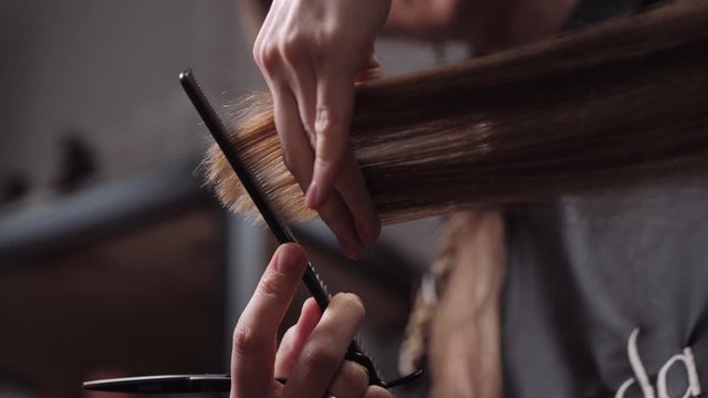 Hair salon girl haircuts. Close up 4K slow motion
