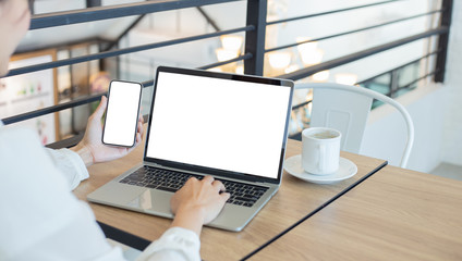 mockup image blank screen computer,cell phone with white background for advertising text,hand woman using laptop texting mobile contact business search information on desk in office.marketing,design