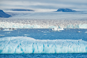 Icebreaker glacier in the sea. Land of ice. Travelling in Arctic Norway. White snowy mountain, blue...