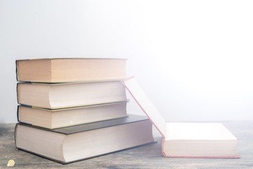 Thick paper books are a symbol of education and wisdom. A stack of books on the table. Storage and...