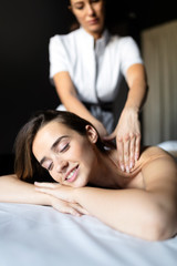 Obraz na płótnie Canvas Masseur doing massage on female body in the spa salon. Beauty treatment concept.