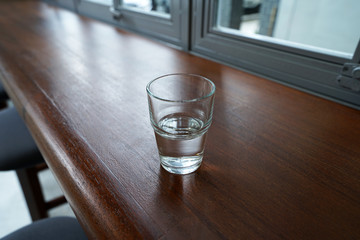 A glass of spring water on wooden table bar