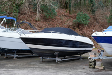 modern boat yachts stored up in dry storage waiting for maintenance