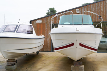 Fototapeta na wymiar new boat for sale dealership stored up in dry storage waiting for hire rent or buy