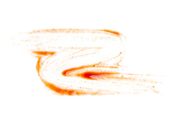 Smeared barbecue sauce or ketchup isolated on white background, close up, macro. Flat lay, top view.