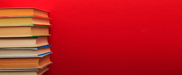  pile of old books, panorma, good copy space  on red background