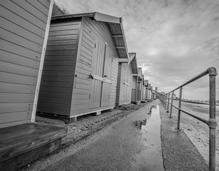 Fototapeta premium Selective focus on a row of colourful traditional wooden beach huts