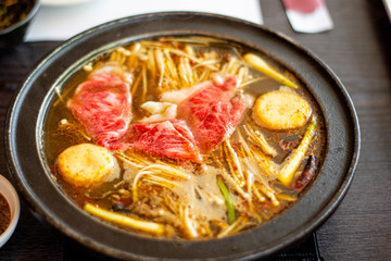 close up of sliced meat (beef) dipping in shabu-shabu soup