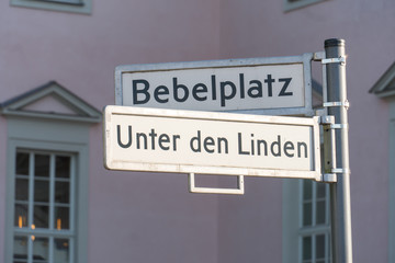 Street name signs of Bebelplatz (formerly and colloquially the Opernplatz) and of Unter den Linden in the central Mitte district in Berlin, Germany