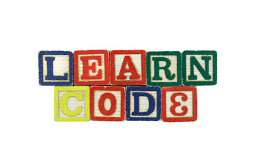 The words Learn Code spelled in colorful wooden blocks 2/2
