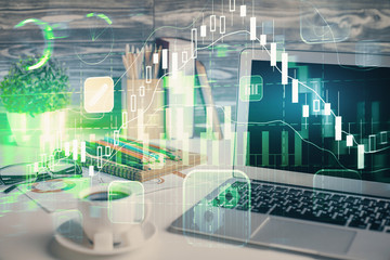 Financial chart drawing and table with computer on background. Multi exposure. Concept of...