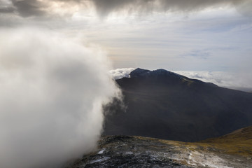 Mount Snowdon in Snowdonia Wales partly obscured by a big bank of low cloud