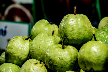 Ripe green guavas  are placed on the fruit stall.
