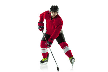 On the run. Male hockey player with the stick on ice court and white background. Sportsman wearing equipment and helmet practicing. Concept of sport, healthy lifestyle, motion, movement, action.
