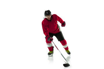 Fototapeta na wymiar On the run. Male hockey player with the stick on ice court and white background. Sportsman wearing equipment and helmet practicing. Concept of sport, healthy lifestyle, motion, movement, action.