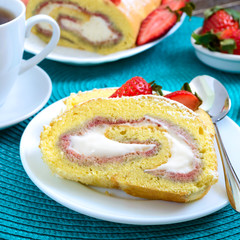 Sweet biscuit roll with strawberries and cream on a wooden background