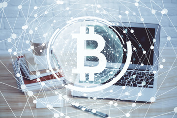 Double exposure of blockchain theme hologram and table with computer background. Concept of bitcoin crypto currency.