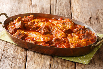 lamb stew with eggplant, onions, spices close-up in a pan. horizontal