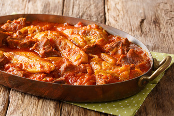 khoresh bademjan, Persian eggplant, meat and tomato stew braised with spices close-up in a pan. Horizontal