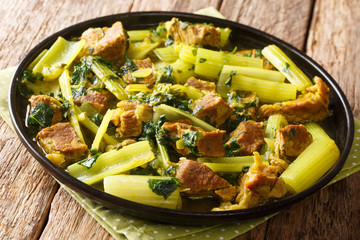 delicious recipe for a Persian stew khoresht karafs of celery celery with beef, onions, mint and parsley close-up in a plate. Horizontal