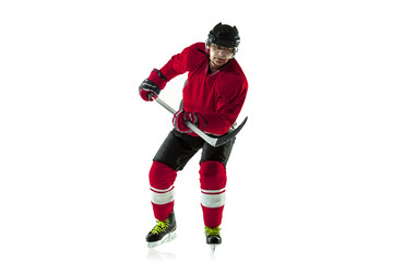 Fototapeta na wymiar Scoring a goal. Male hockey player with the stick on ice court and white background. Sportsman wearing equipment and helmet practicing. Concept of sport, healthy lifestyle, motion, movement, action.