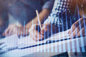 Multi exposure of two men planing investment with stock market forex chart.