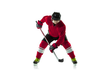 Activity. Male hockey player with the stick on ice court and white background. Sportsman wearing equipment and helmet practicing. Concept of sport, healthy lifestyle, motion, movement, action.