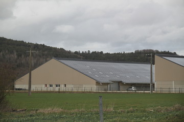 Fototapeta na wymiar Solar panels installation on a farm roof