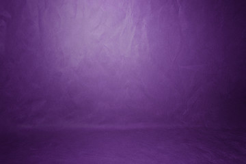 Studio background, backdrop wall and floor. Background Studio Portrait Backdrops painted canvas or fabric for use with portraits, products and concepts. Light spot on a purple fabric background.