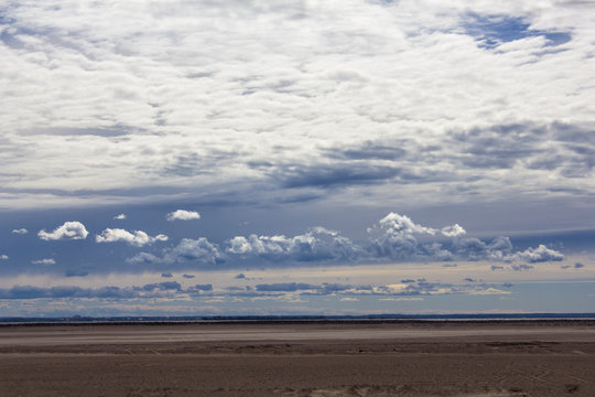heavy rain cloudy sky over a sandy desert against the backdrop of the city